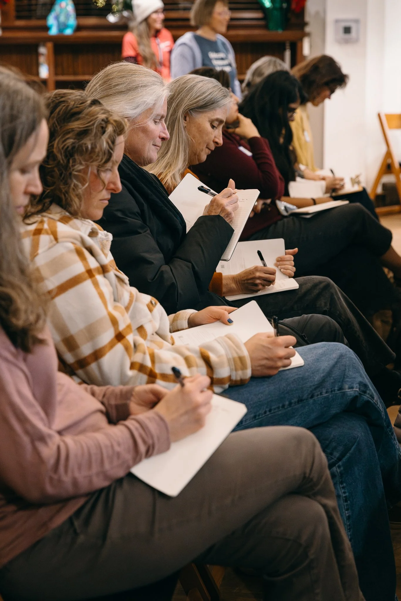 Event attendees taking notes during a community workshop in Boulder, Colorado.
