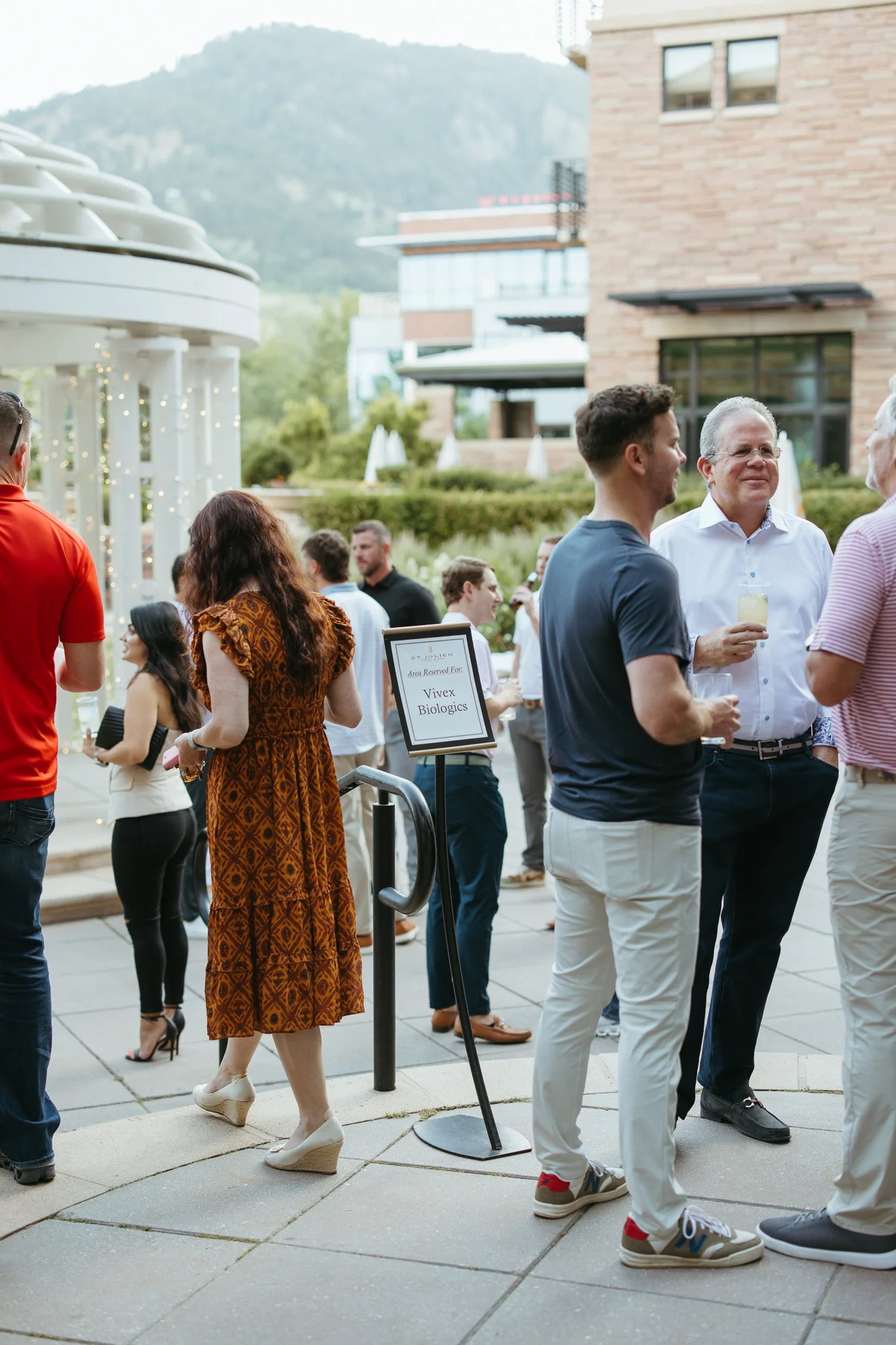 Colleagues networking during an outdoor corporate retreat reception in Boulder, Colorado.