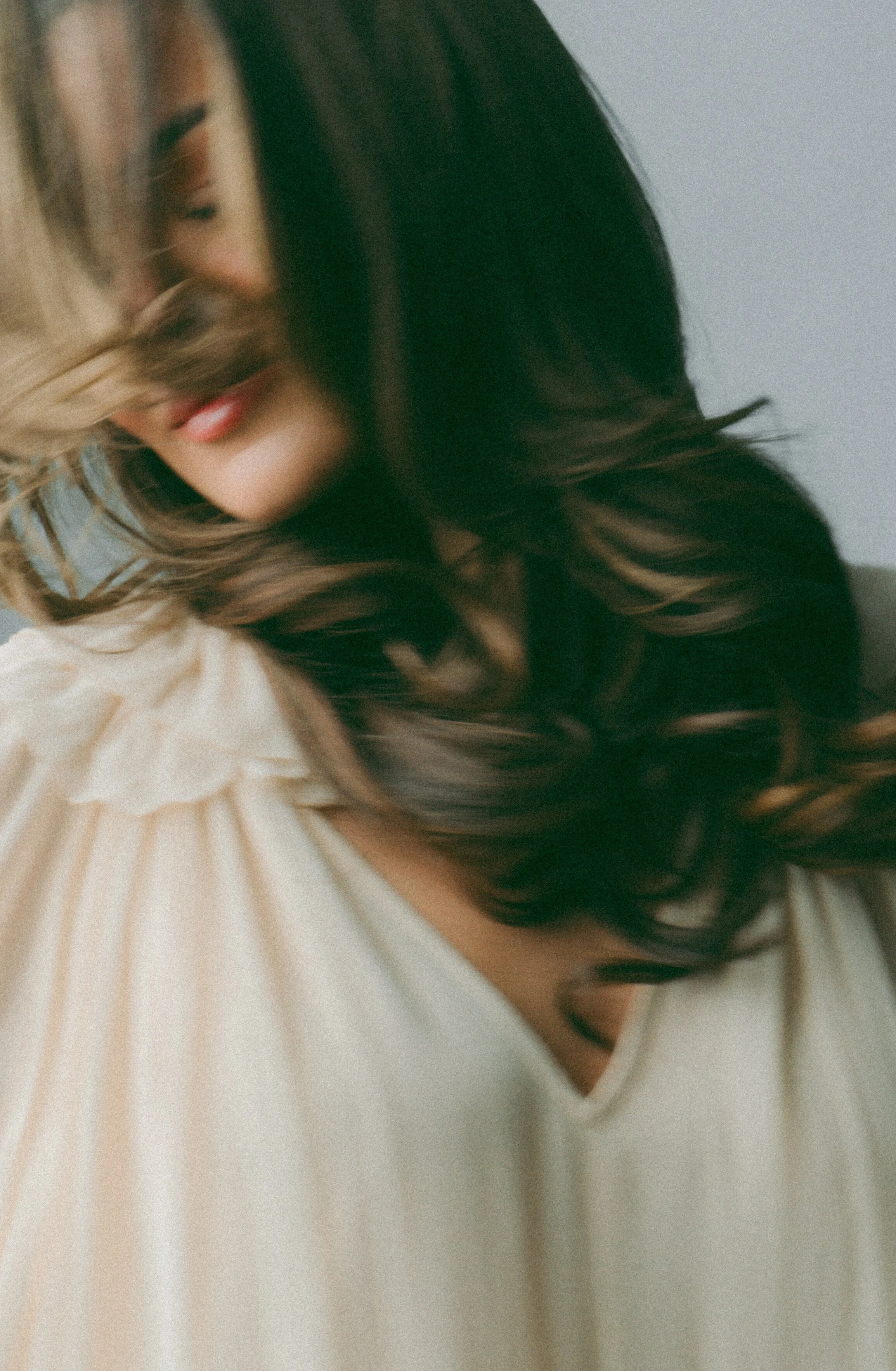 Woman enjoying a smooth, glossy blowout after hair wash, soft and bouncy hair at Amada Lash Studio