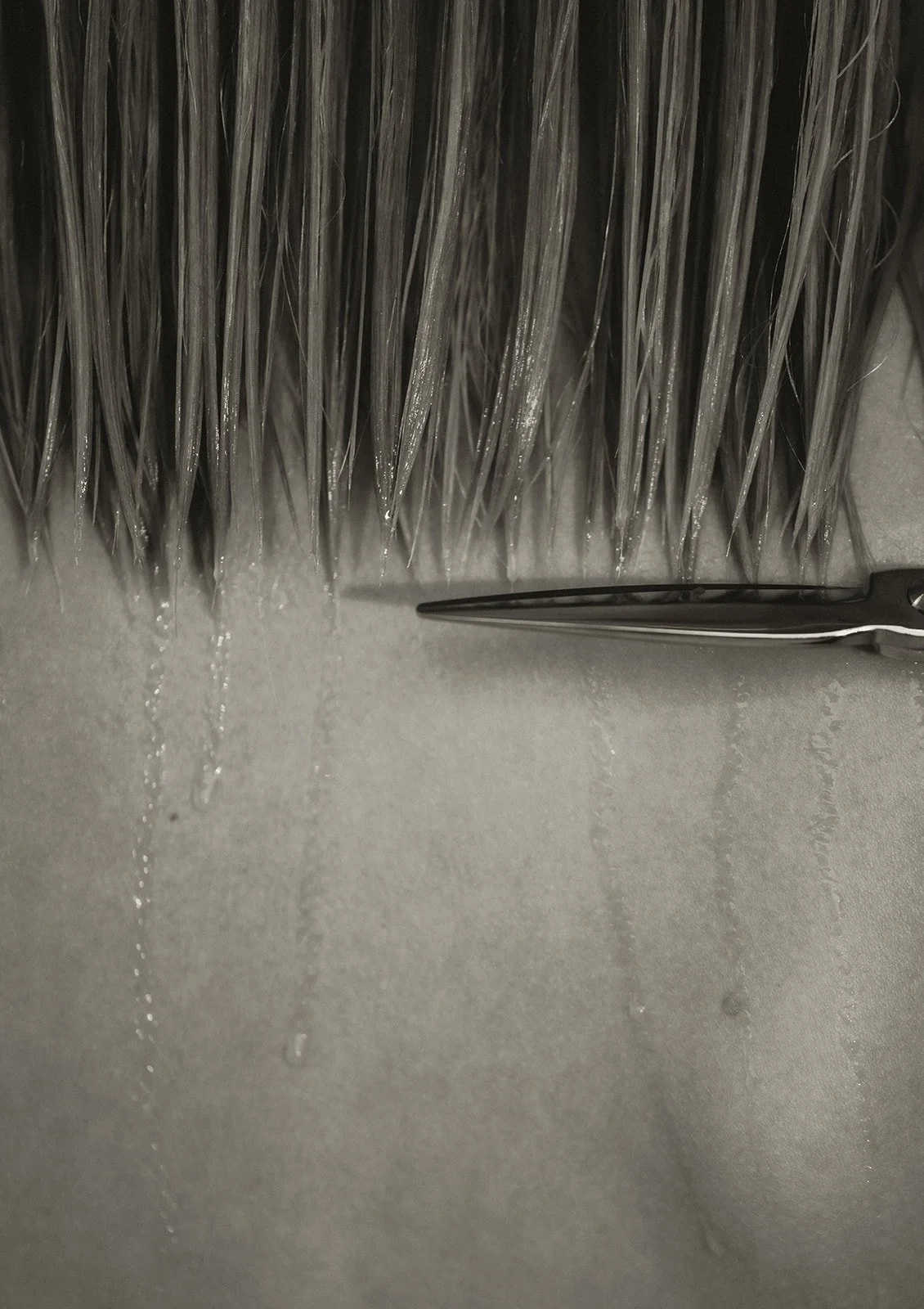 Hair stylist trimming client’s hair with precision, creating a fresh, stylish haircut at Amada Lash Studio