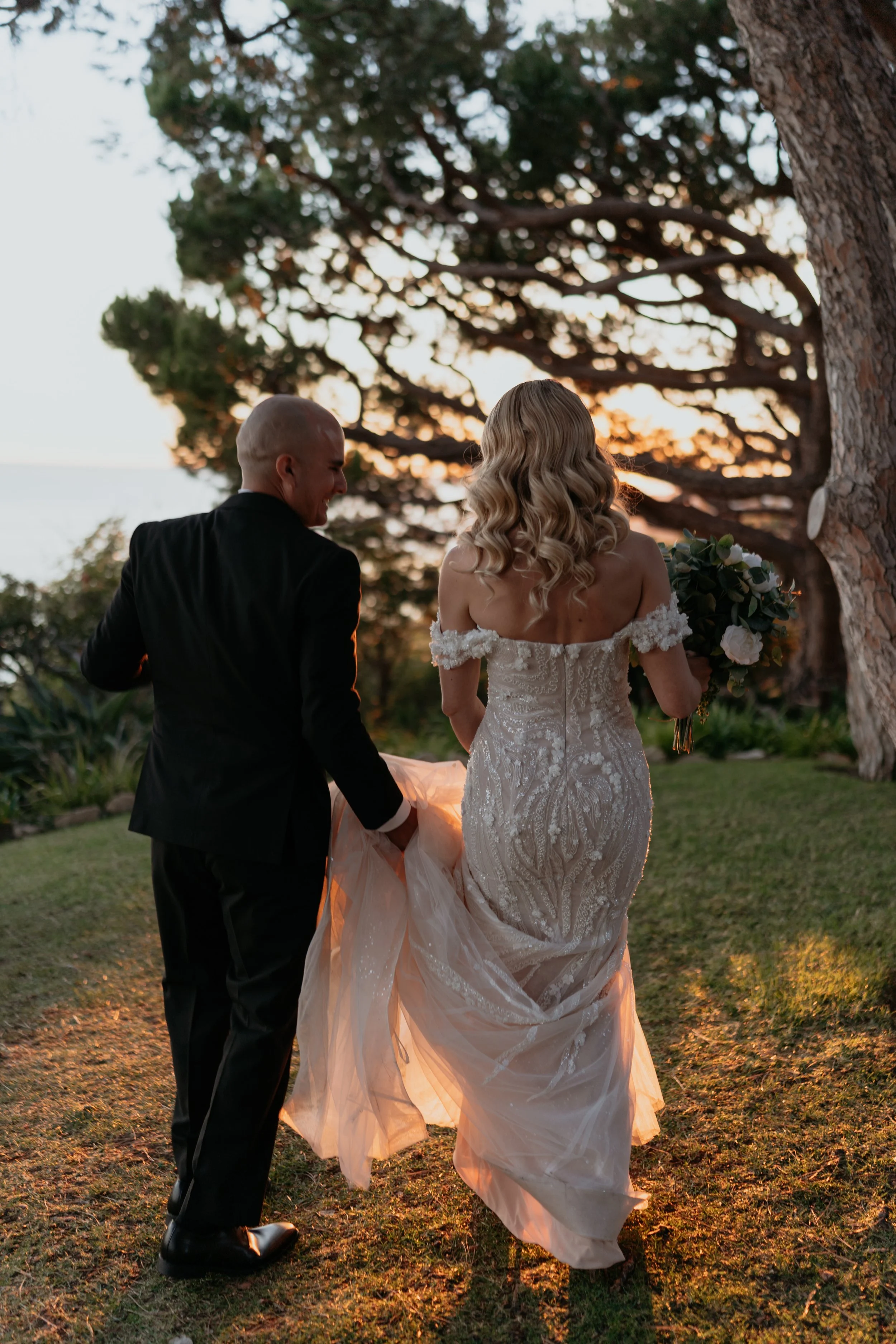 Laurie’s customers, Fernando and Kate embracing by the lake on their wedding day.