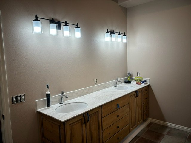 New counter tops and vanity lights in a residential bathroom remodel.