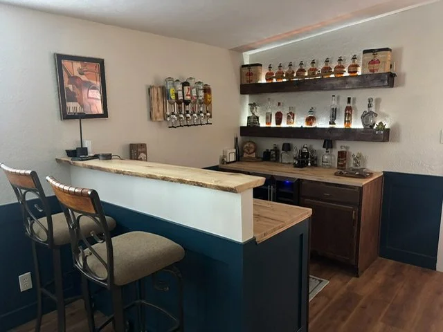 Custom designed bar including wall mounted bottle dispensers