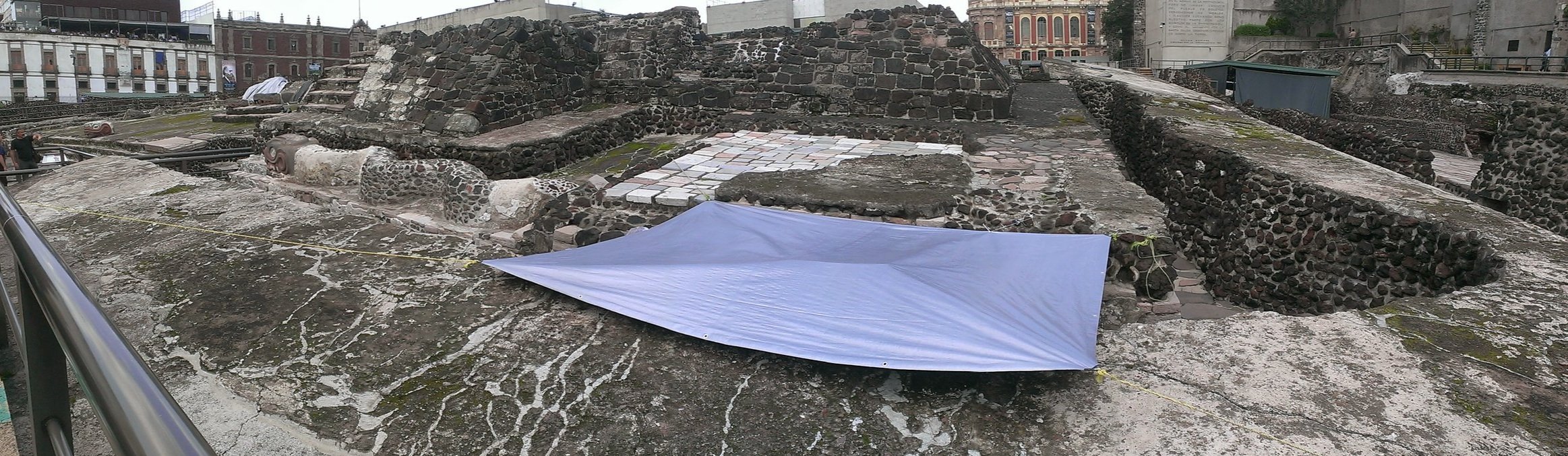 Figure 2. Front view of the Templo Mayor site, partially covered, serpent sculpture on left while walking into the National Anthropology Museum in Mexico City (Whitehouse 2014).