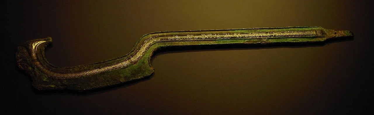 Figure 23. Khopesh from Egypt, 18th century BCE, found in&nbsp;Nablus; the blade is decorated with&nbsp;electrum&nbsp;inlays.