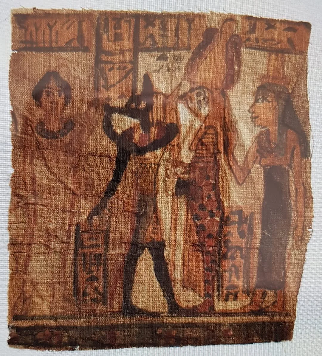 Figure 24. A section of a shroud.  The painted scene depicts a dead Tashay, who is presented by Anubis to Sokar-Osirus attended by goddess Nephthys. 140-160 CE, Graeco-Roman Period 