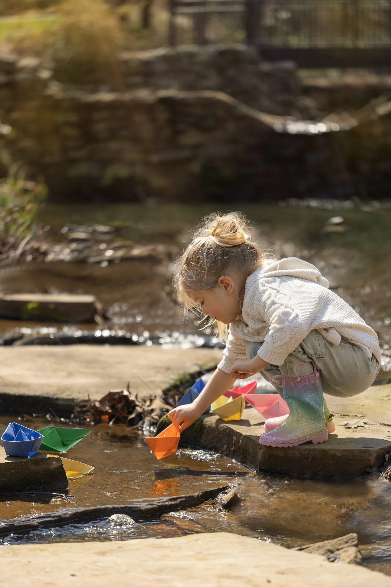 2026_03_01_IMG_0978 Girl Puts Paper Boat.jpg