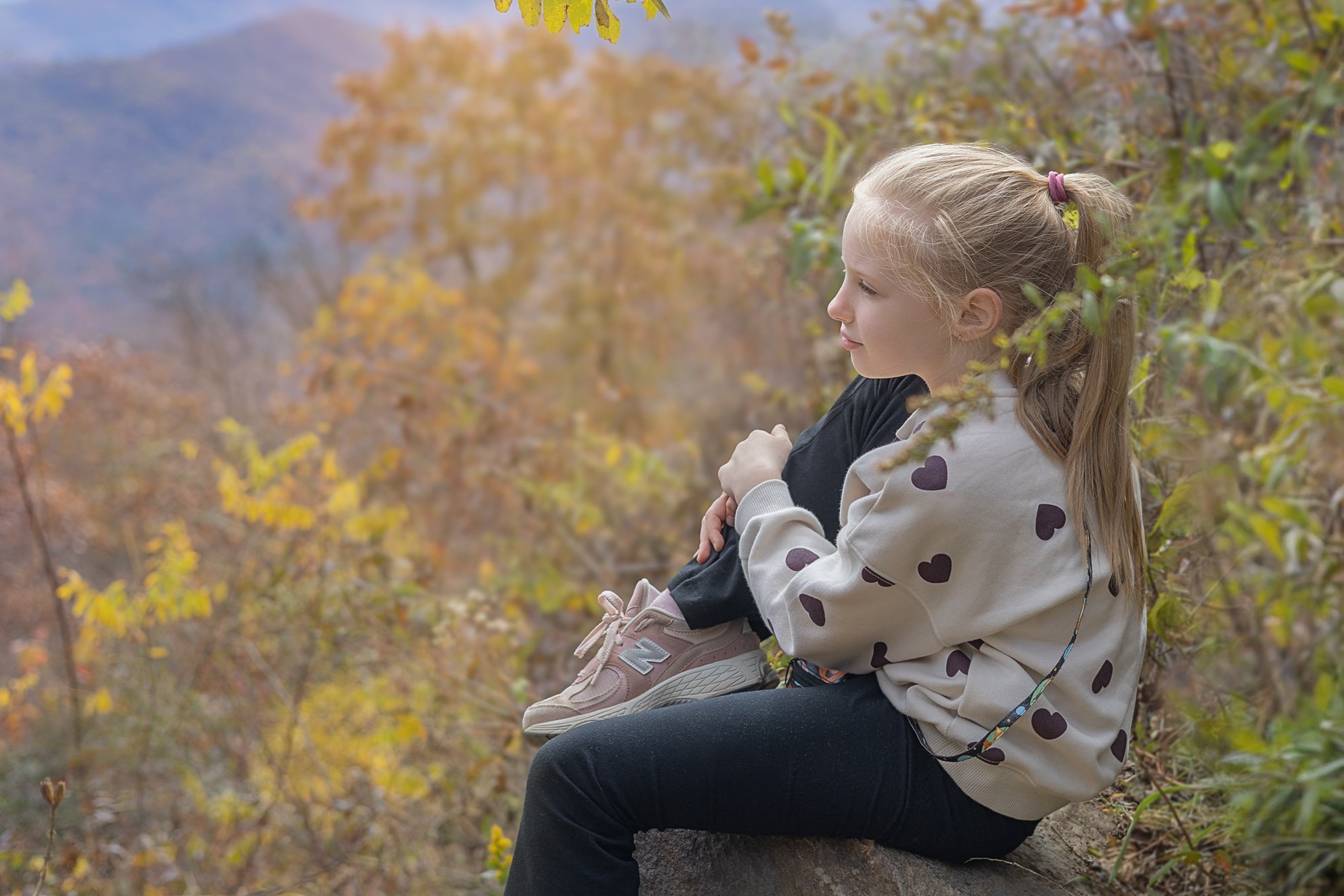 Girl looks at Mountains