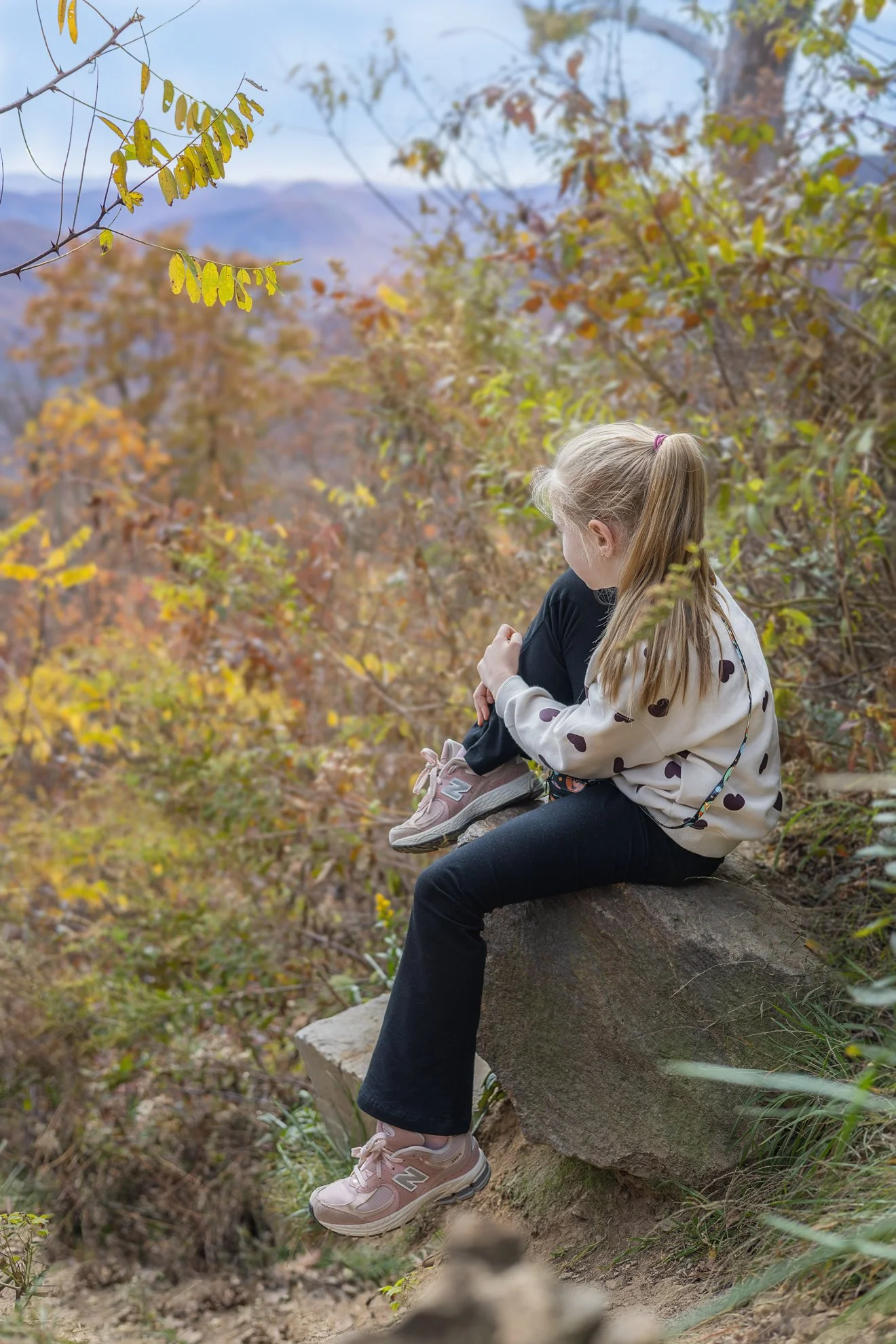 Girl looks at Mountains