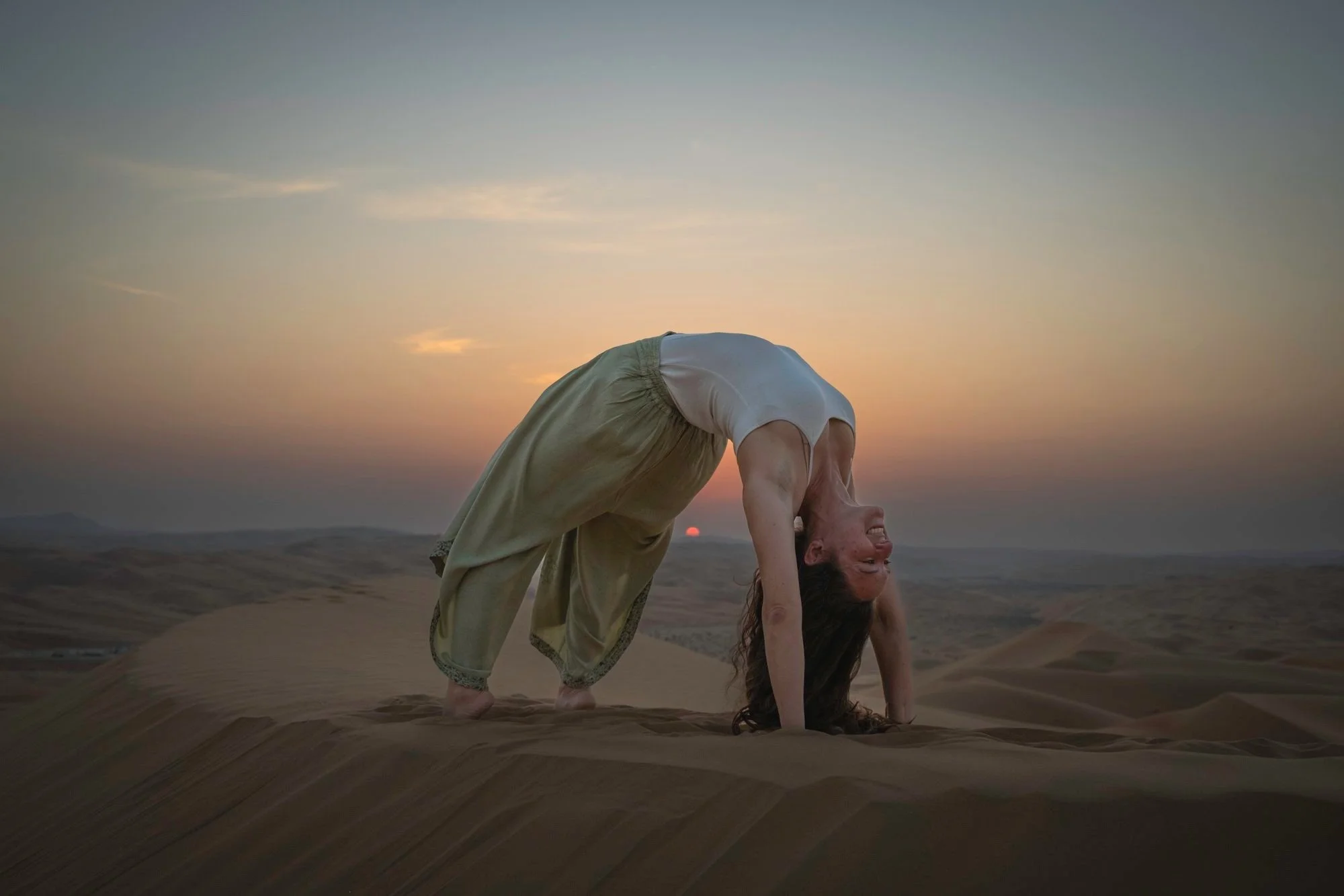Yoga teacher doing a backbend in the desert