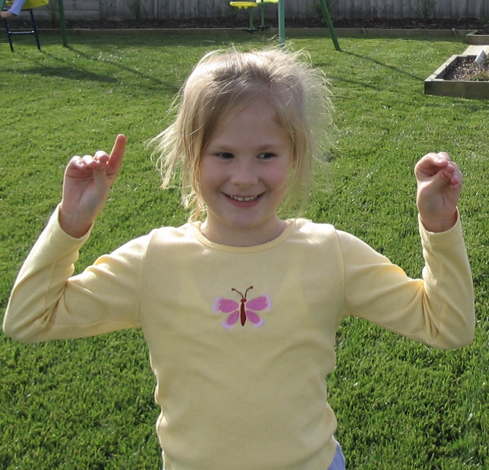 Shay as a young girl in the backyard