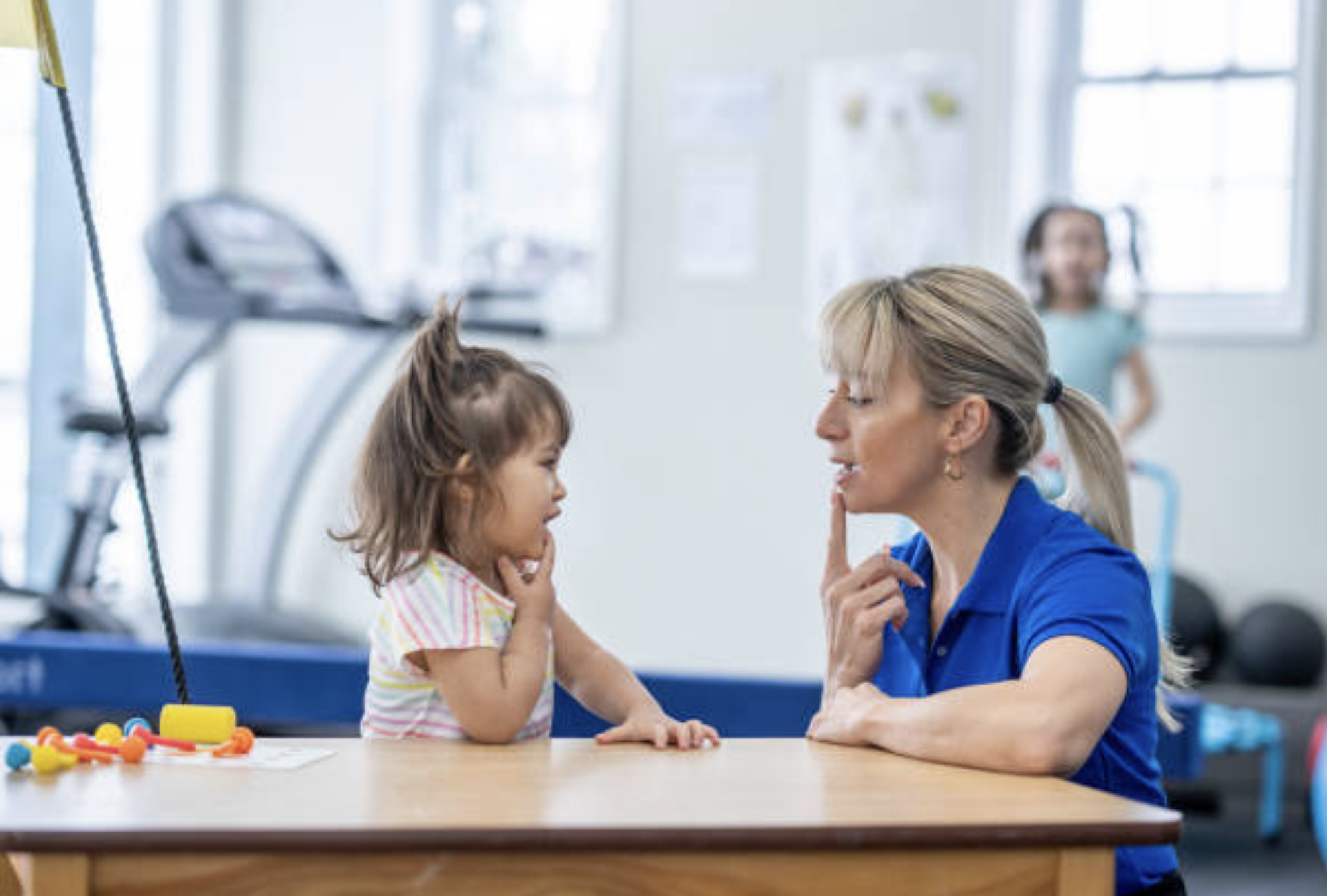 Therapy assistant supporting a child in a session