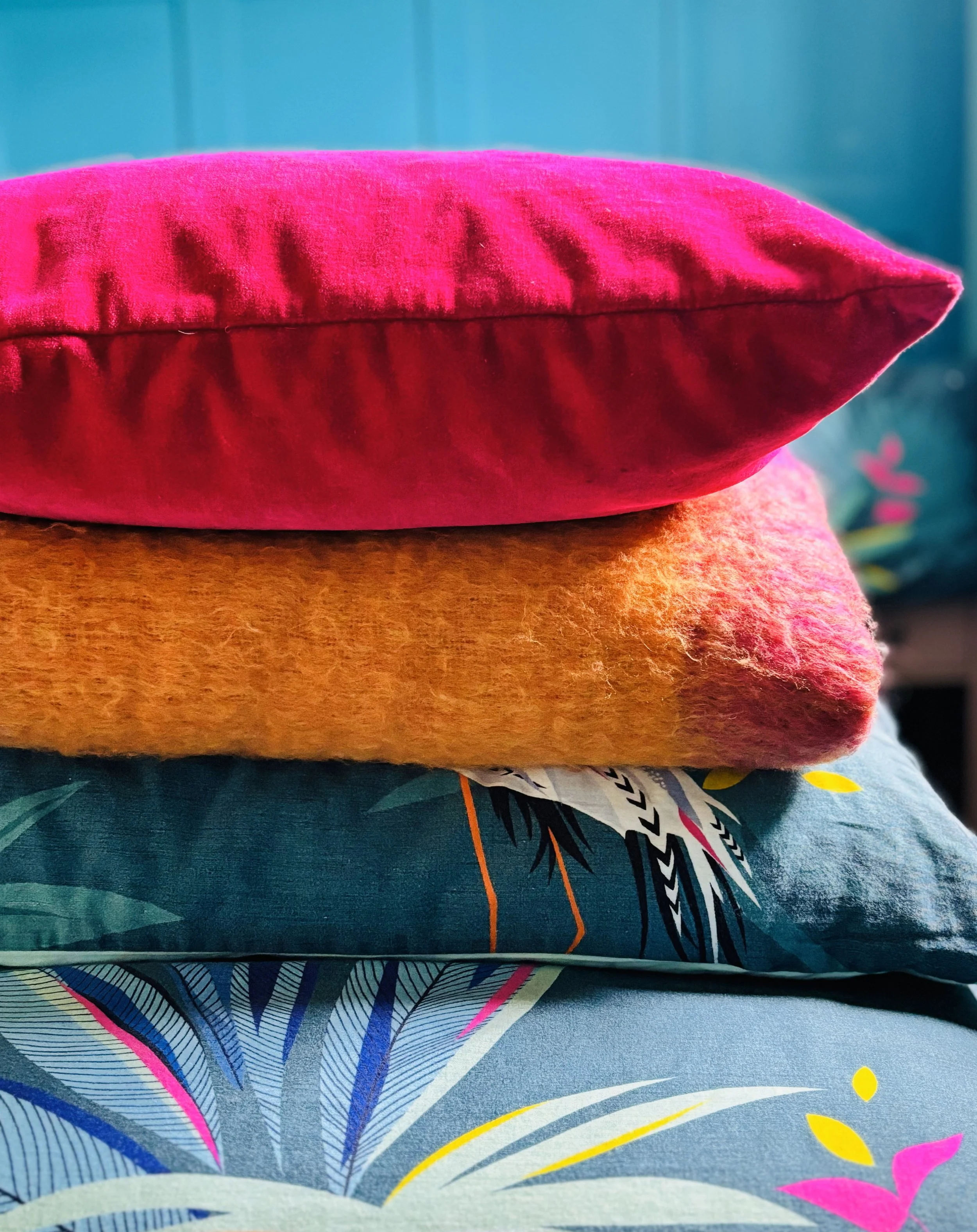 Brightly coloured cushions, duvet and throw