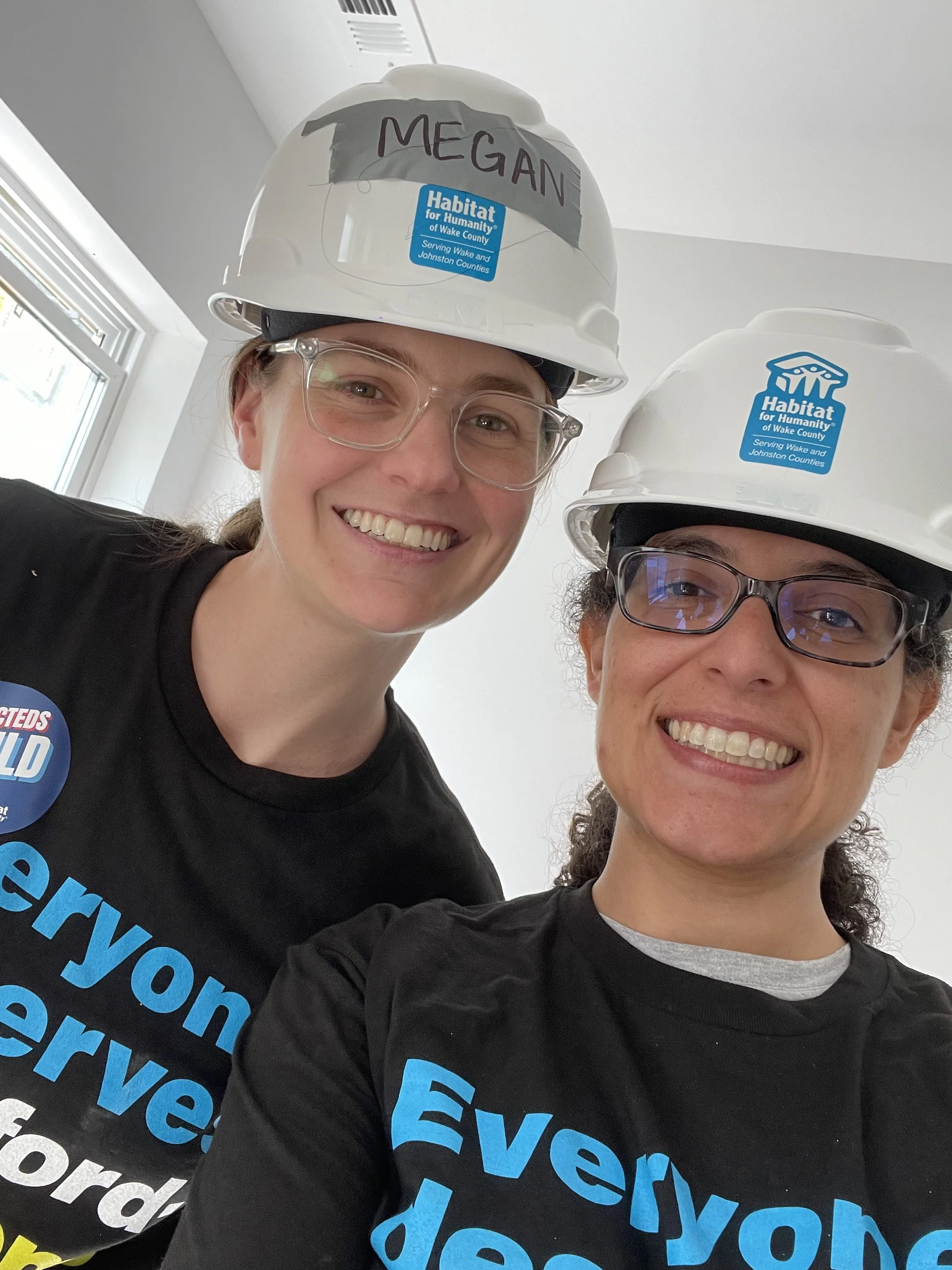 CM Patton and CM Jones pose for a selfie with hard hats, while at a Habitat for Humanity build