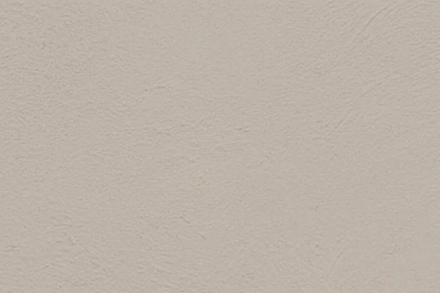 Close-up of a beige, textured wall or ceiling surface.
