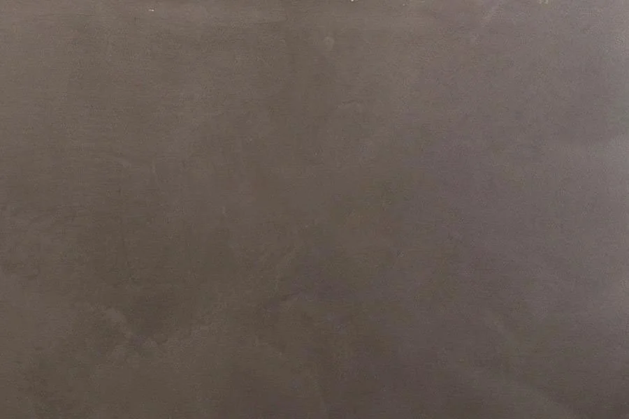 Close-up of a dark, textured surface, possibly a table or countertop.