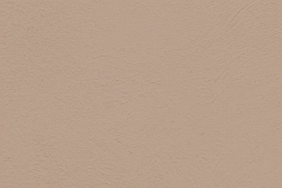 A plain beige textured wall.