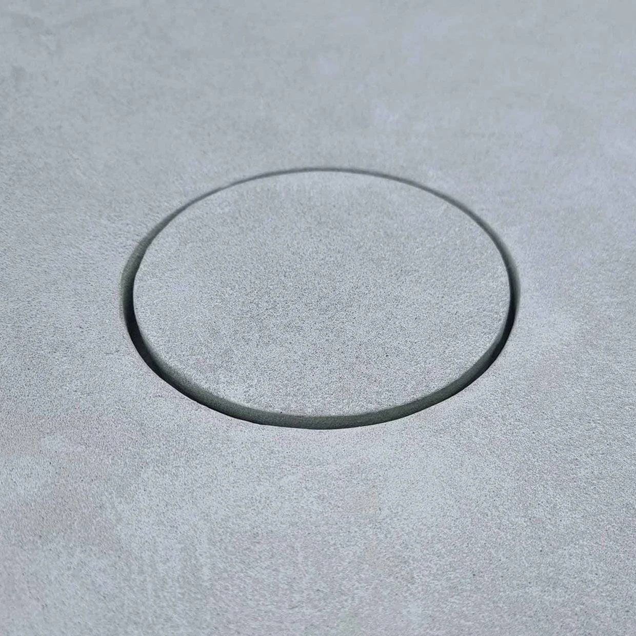 Close-up of a circular button or knob on a metallic surface.