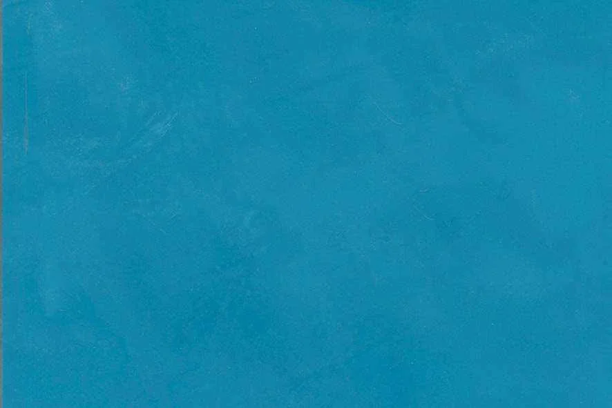 Close-up of a blue textured surface, possibly paper or fabric.