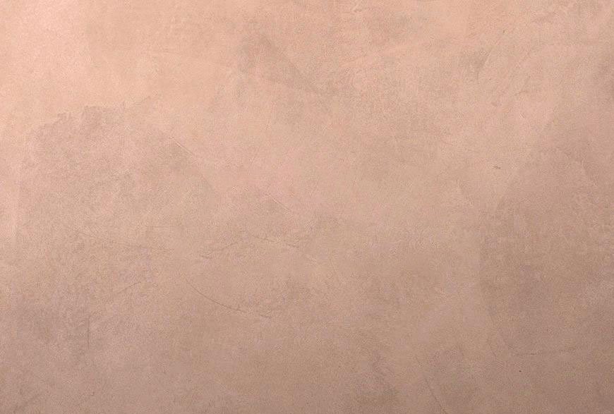 Close-up of a light pink textured wall or surface.