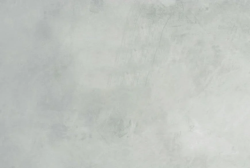 Close-up of a plain, light gray concrete wall surface.