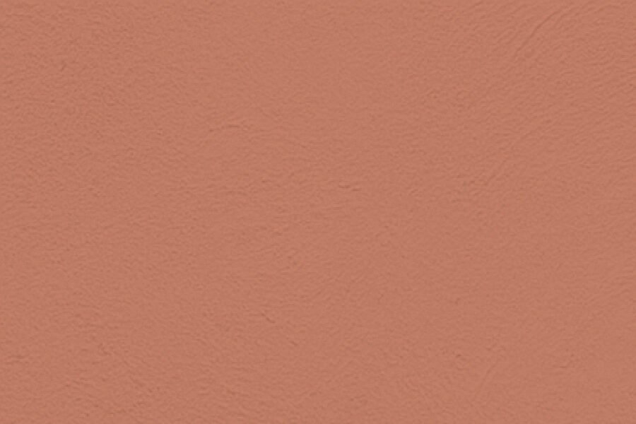 Close-up of a pinkish-orange textured wall.