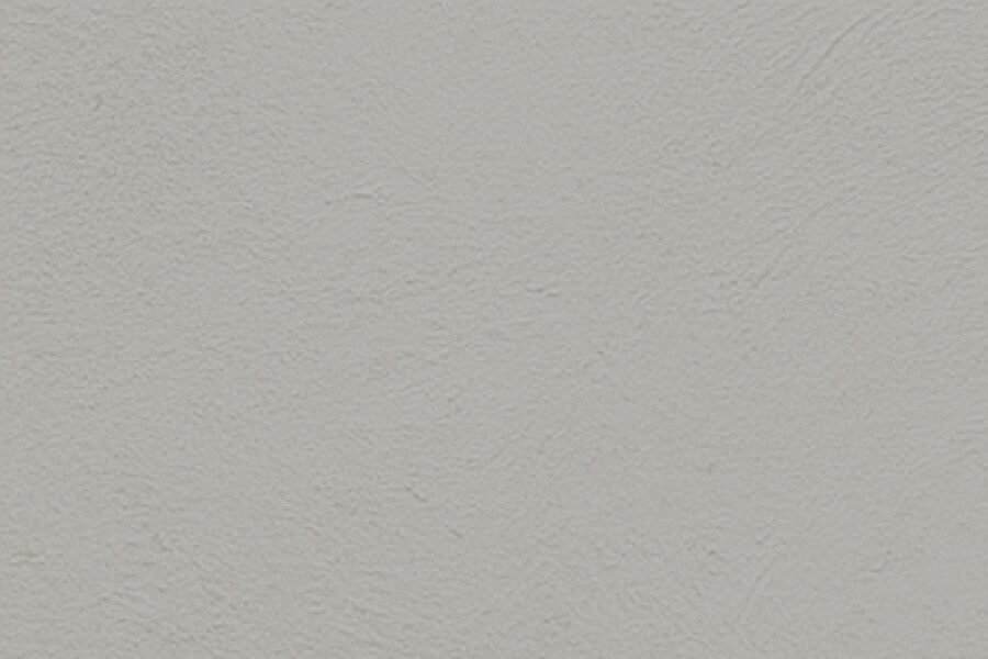 Close-up of a textured, beige ceiling or wall surface