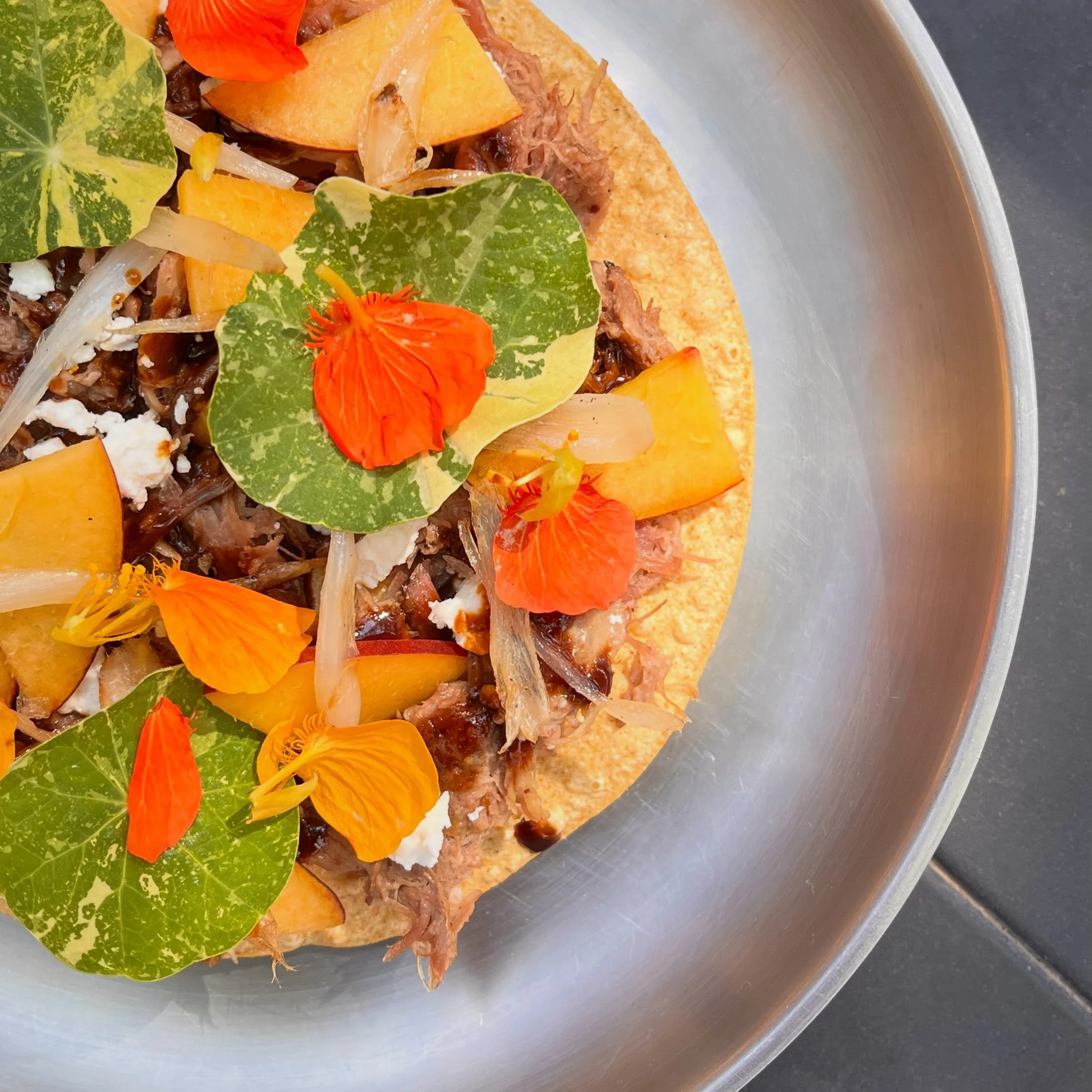 braised lamb tostada: neck, head and shank, mol&eacute; poblano, ch&egrave;vre, nectarine, nasturtium, ramp bulb

On tonight