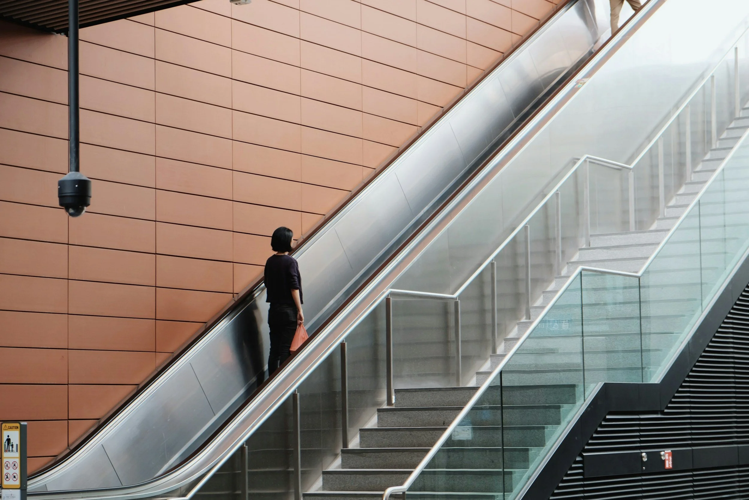 Person riding an escalator – escalator inspection