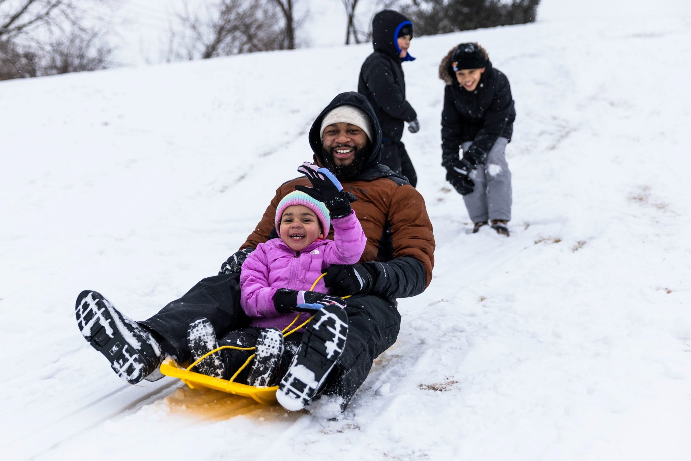 Quentin Ponius sleds down a hill with his daughter Makenna Ponius, 3, after a snowstorm on Wednesday, February. 12, 2025, at Twin Sister Hills Park in Rockford.