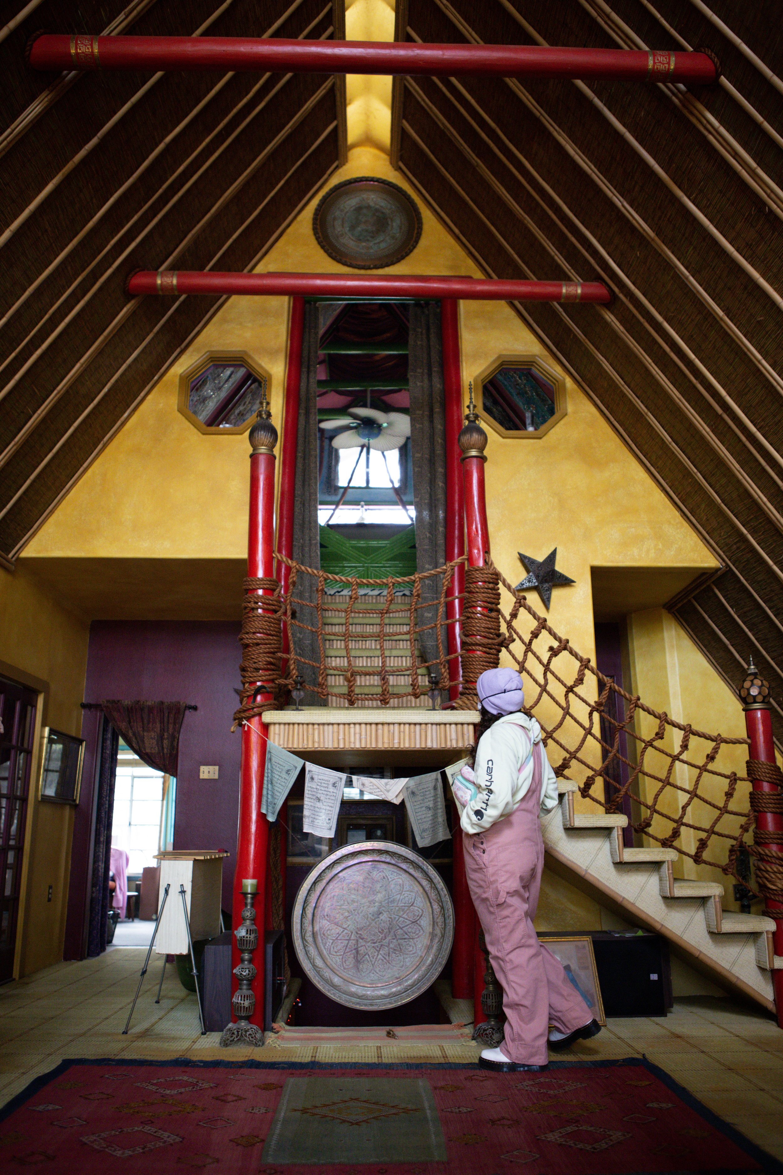 A tour attendee looks at his staircase leading to his third floor bedroom which was added in 1998. Talbot added the “bali-inspired” second floor and third floor bedroom 17 years after moving into the house.