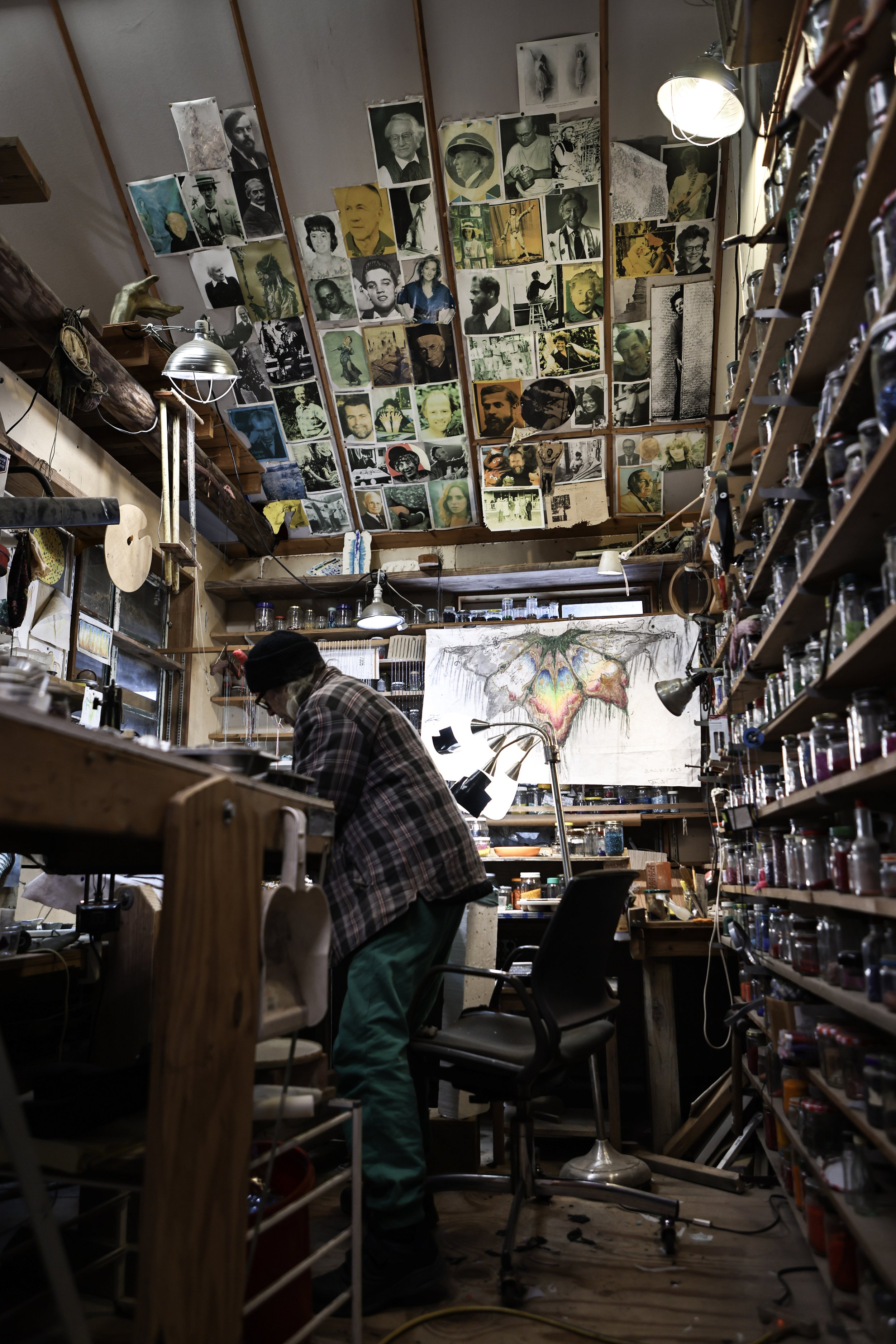 Above his small beading workstation hangs pictures of friends, inspirations, and muses that inspire him to create his art.