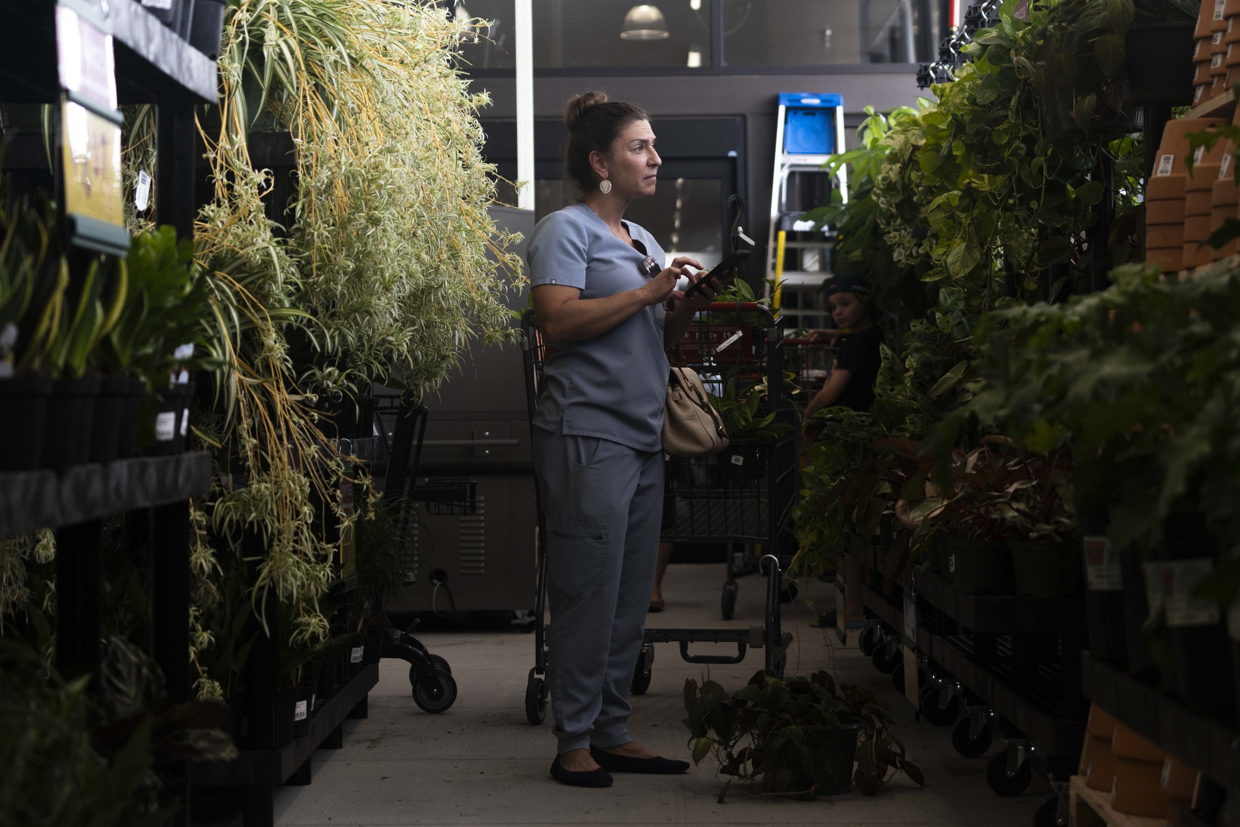 Customer Michelle Gillespie shops for plants in the Texas H-E-B Backyard section of the new Nutty Brown H-E-B on its opening day on Wednesday, July 5, 2023.