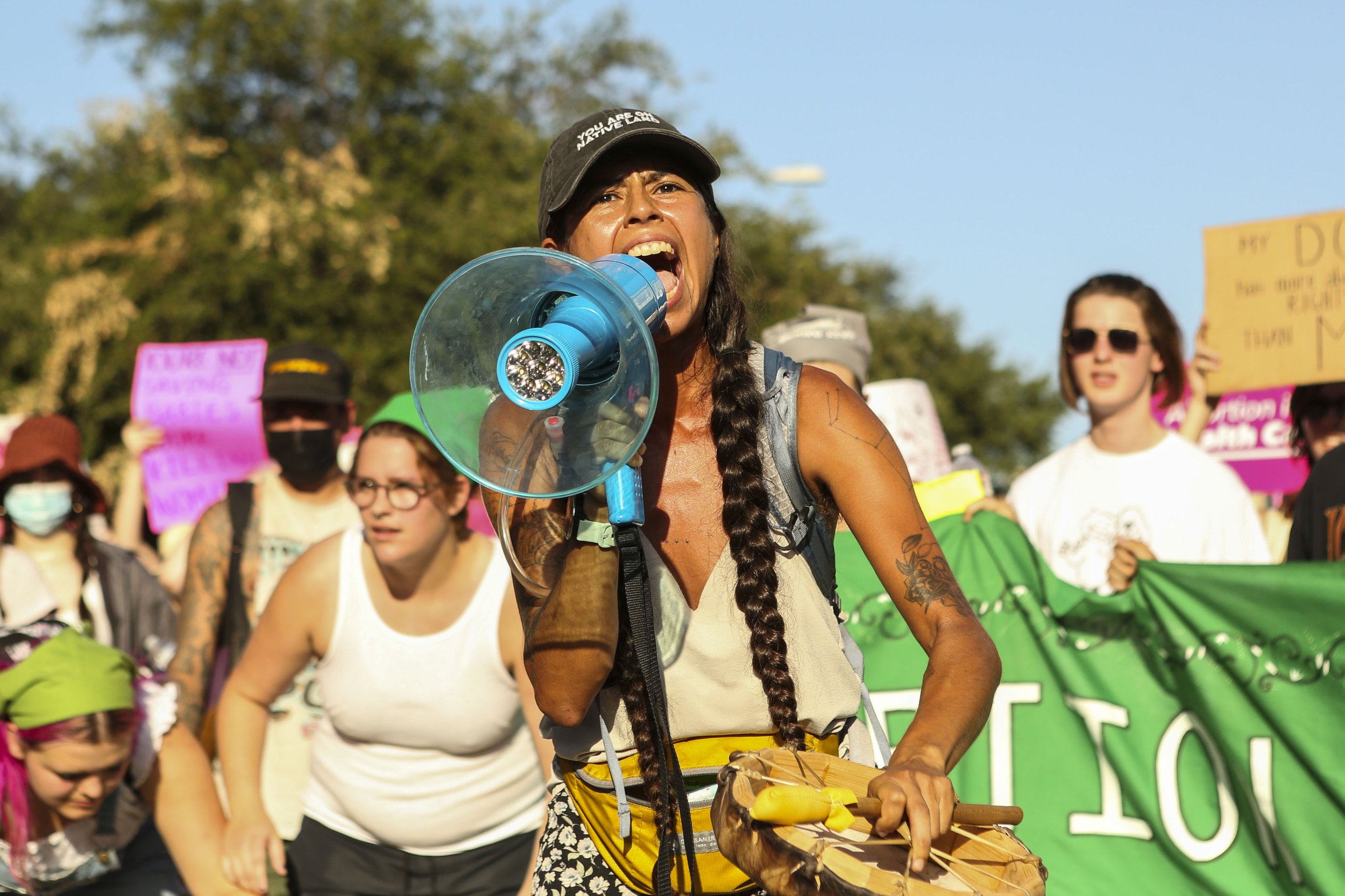 Abortion activist Chiara Beaumont yells into a megaphone during an abortion rights protest in front of the Texas Capitol on June 24, 2022. People took to the streets in reaction to the overturing of Roe v Wade, a Supreme Court case that protected abo