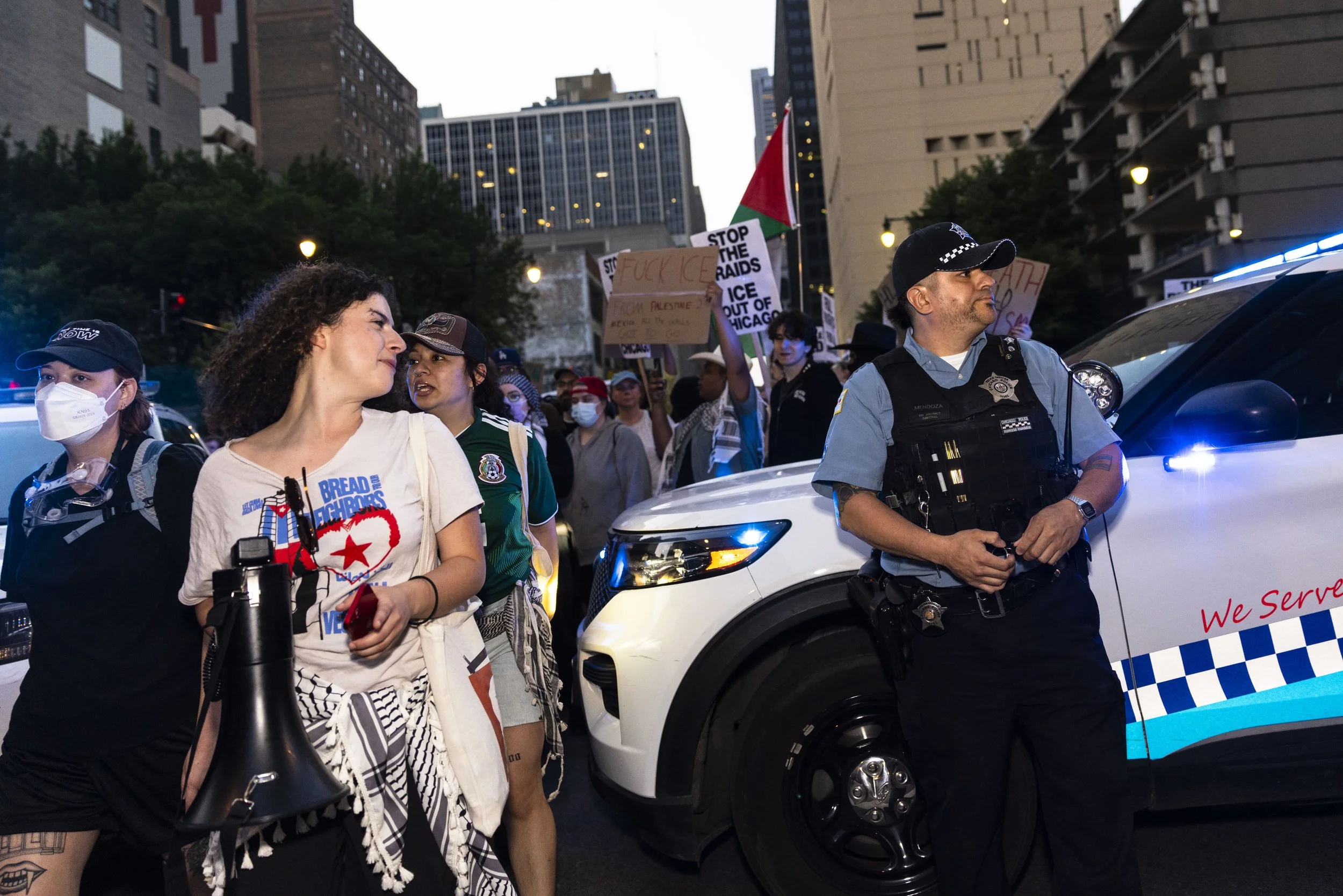 Protesters walk past a police blockade during a protest against federal immigration policy and ICE on Tuesday, June 10, 2025, in downtown Chicago.