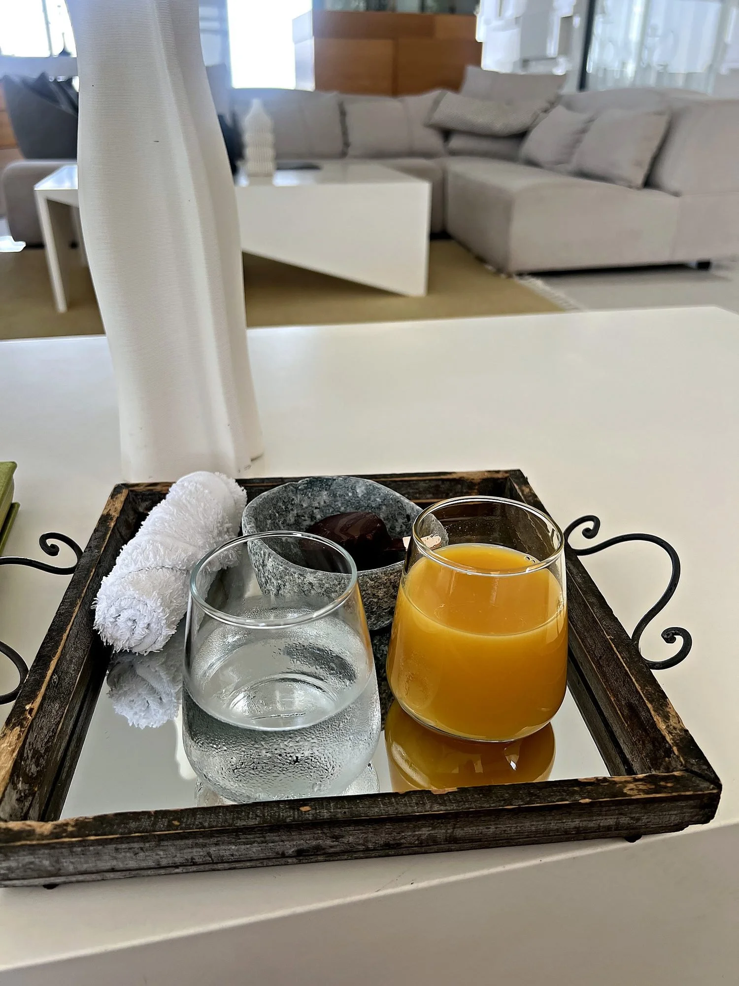 A tray of water, fresh orange juice and a chocolate ice cream bar. What lesante blu brought me during check in.