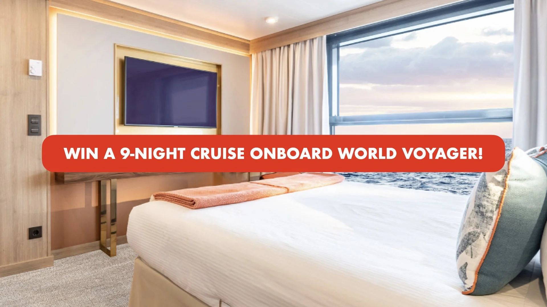 Interior of a hotel room with a bed facing a window showing the ocean. There is a large flat-screen TV on the wall and a red promotional banner across the image that reads: 'Win a 9-night cruise onboard World Voyager!'.