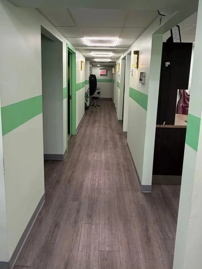 hallway white walls green strip through middle of walls showing entry to operatories
