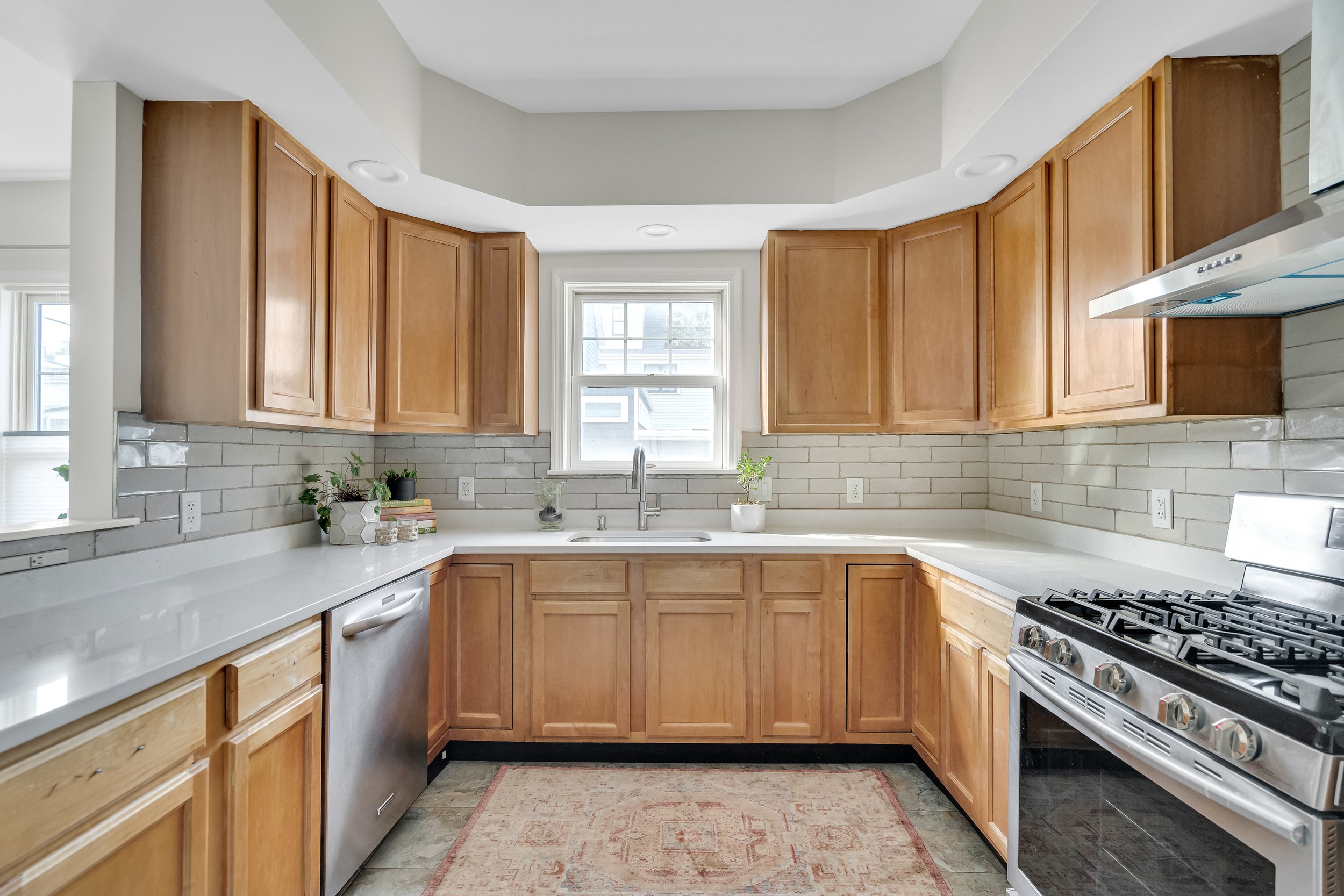 Maintaining existing cabinets and appliances, we brightened and enhanced the space with new countertops and expanding the backsplash. Somerville FALL 2024