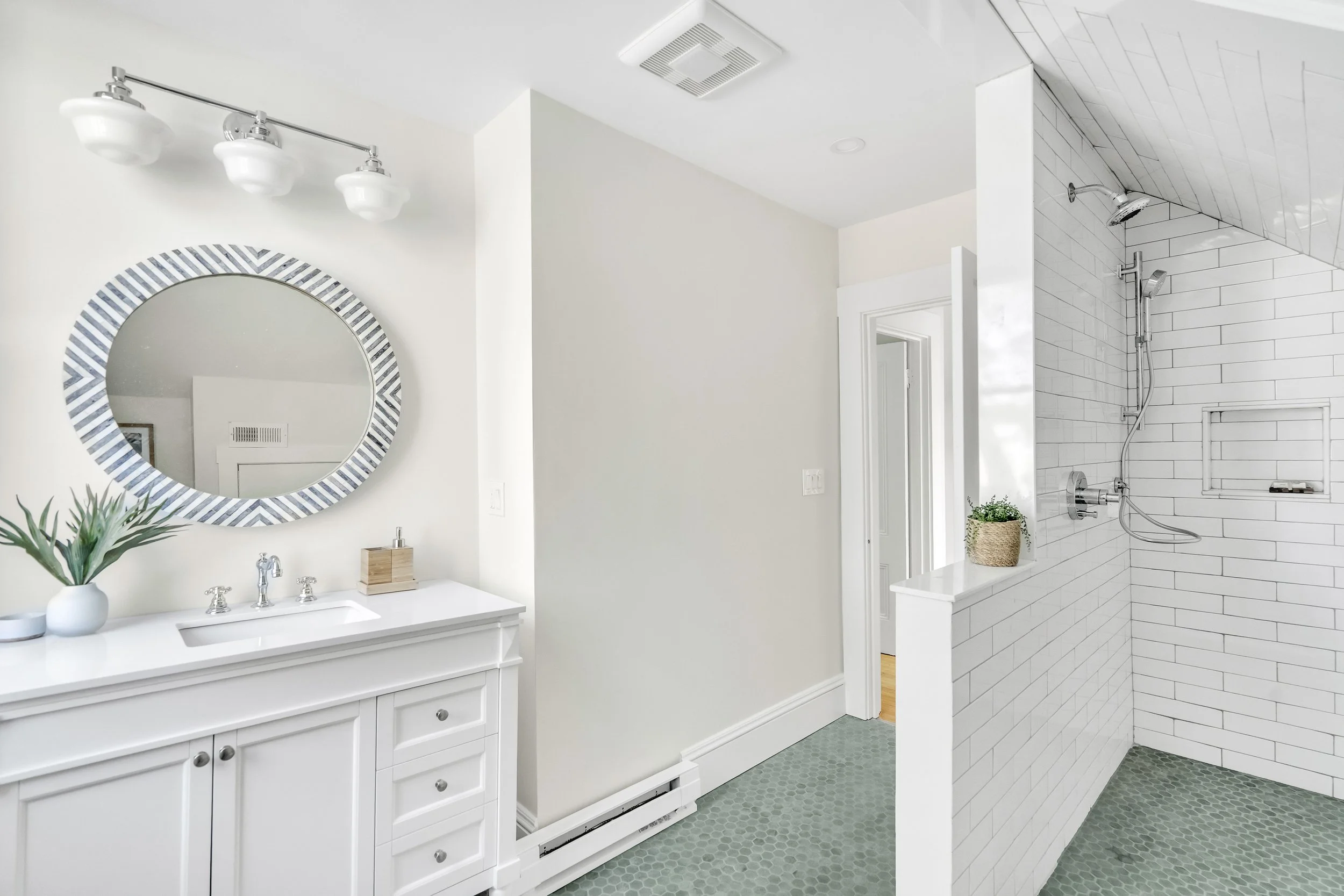 Relocated the bathroom door to the common hallway, and created a large step-in shower.