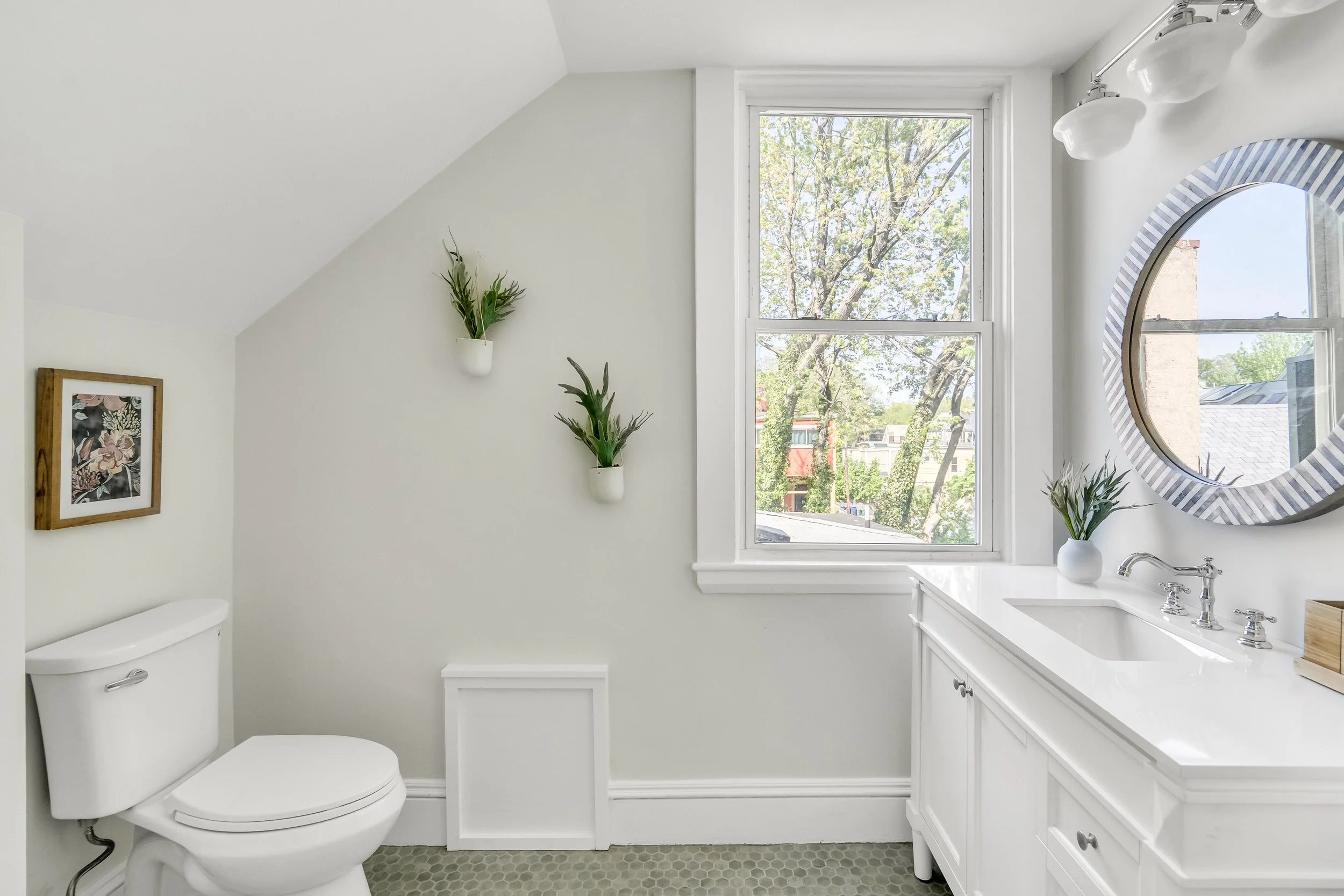 Removed the standing shower and replaced the vanity, flooring, and lighting.