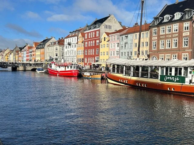 Colorful waterfront houses and boats at Nyhavn Harbor in Copenhagen