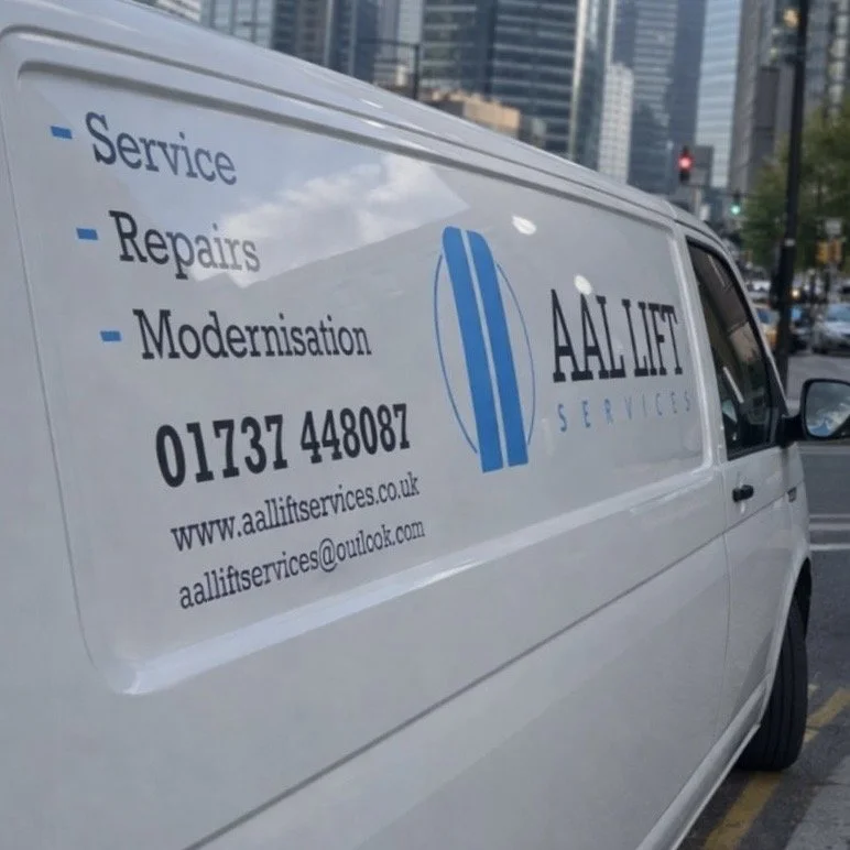 White service van with blue and black text advertising AALIFT SERVICES, including services like service, repairs, and modernization, with contact information and website.