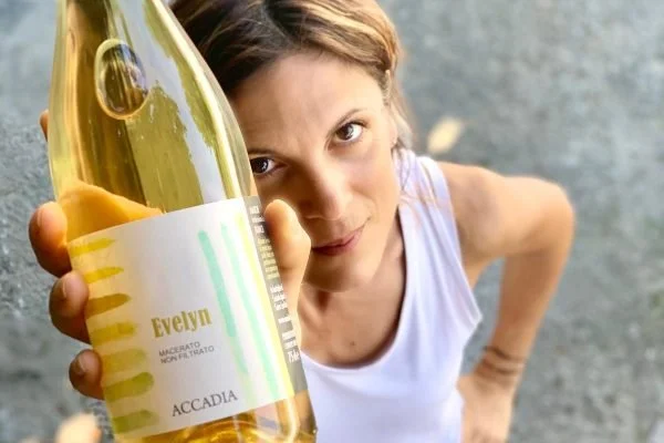 The winemaker holding her bottle of Evelyn