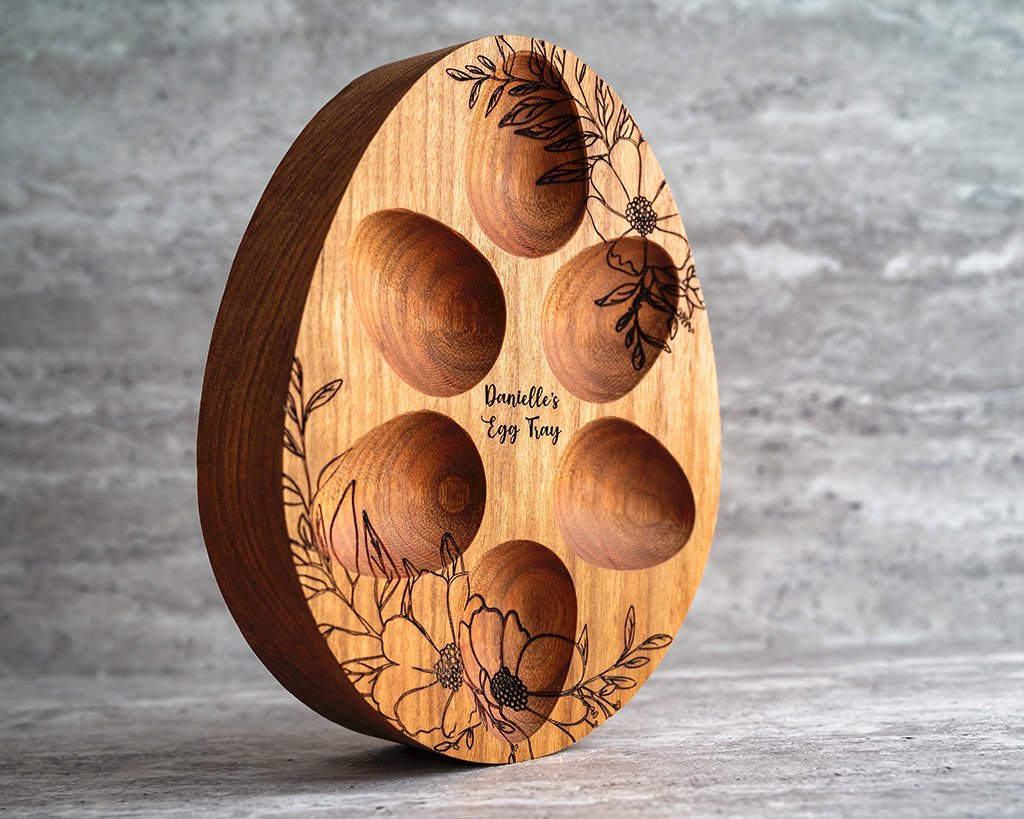 Customized small wooden egg tray with engraved flower patterns.