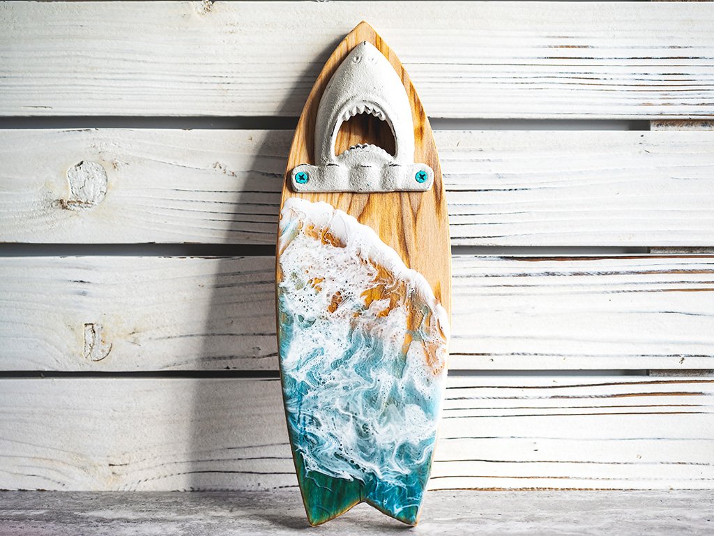 Unique bottle opener with a surfboard shape, shark bite detail, and beach wave design.