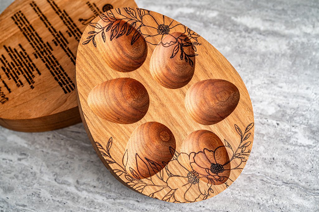 Small wooden egg tray featuring detailed floral carvings.