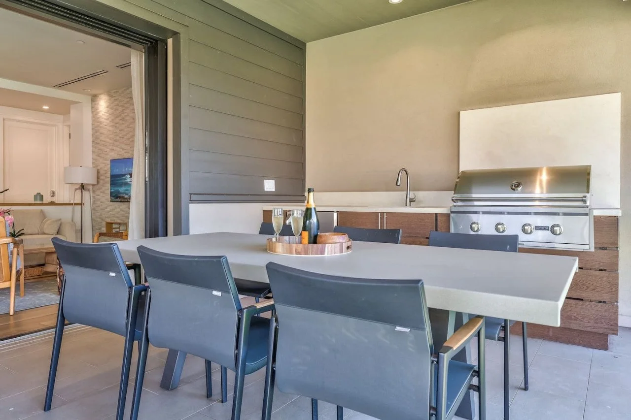 The Lanai offers an outdoor kitchen with a Coyote Grill, sink and under counter fridge.