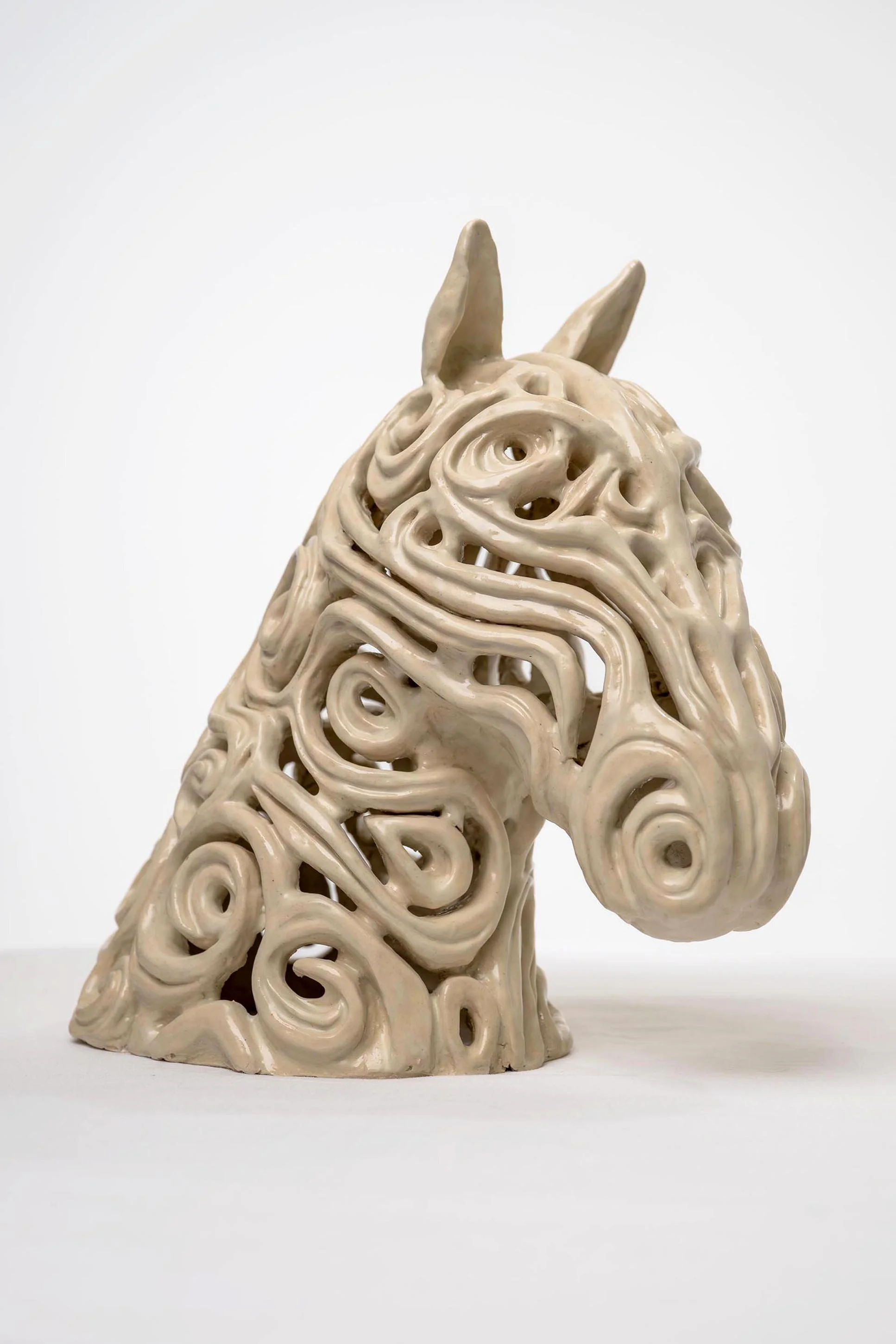 sculpted horse head with woven looking coils.