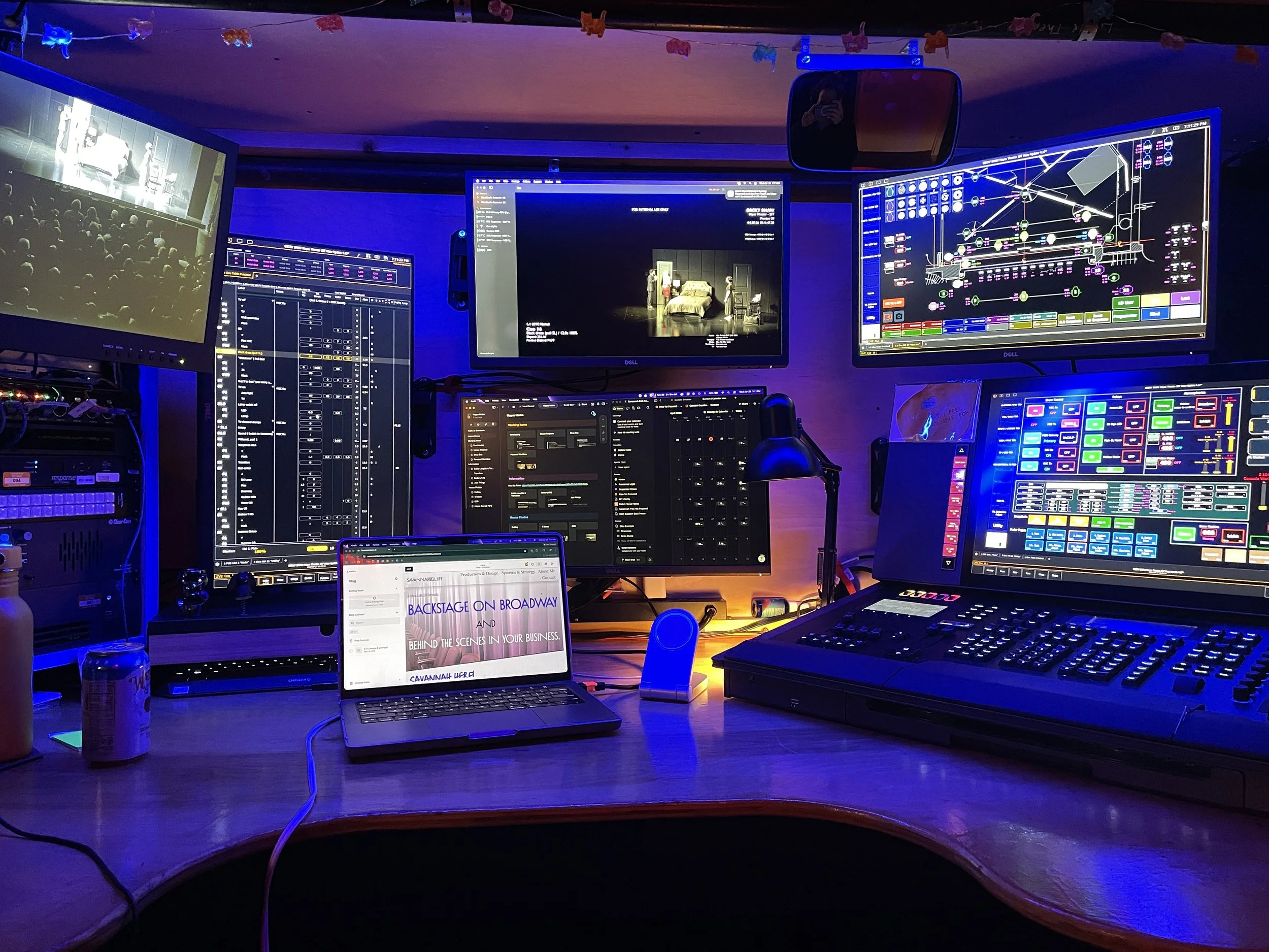 Blog's main photo of the show run position with lighting console, video screens and computer with Savannahbell.life's homepage on it.